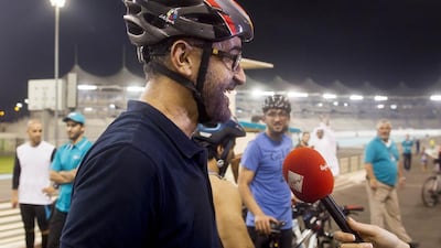 Sheikh Mohammed bin Zayed, centre, speaks to the media after riding his bicycle around Yas Marina Circuit during the weekly TrainYAS event in October. Ryan Carter / Crown Prince Court — Abu Dhabi