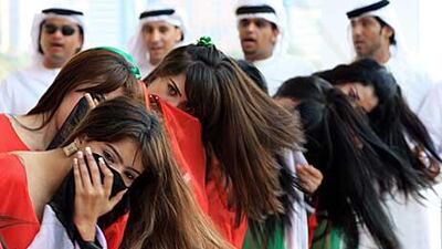 Emirati men and women perform traditional dance at the breakwaters yesterday in Abu Dhabi.