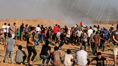 Tear gas canisters fired by Israeli forces landing amid protesters during a demonstration along the border with Israel east of Gaza City. AFP