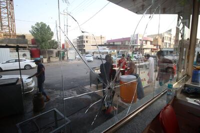 Broken window of a restaurant in Basra. Iraq has been hit by protests. AFP