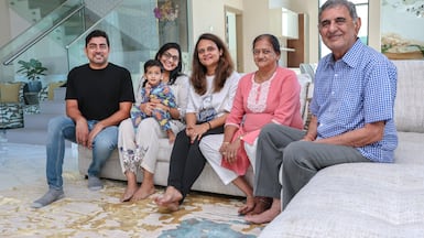 From left: Naveen Nahata, two-year-old Vansh Nahata, Deepika Nahata, Poonam Jain, Sayar Devi Nahata and Raj Kumar Nahata in their home. Victor Besa / The National