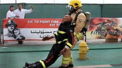 Maged Ahmad Khalifa of AssetCo is cheered on during the individual competition where firefighters from all over the UAE competed in the Firefighter Championship at Adnec.