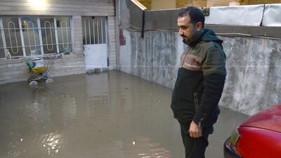 An Iraqi man stands at his flooded house in Mosul. EPA