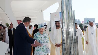 Queen Elizabeth II with Sheikh Mohammed bin Rashid, Vice President and Ruler of Dubai, viewing a replica of Burj Khalifa during a state visit to the UAE on November 25, 2010. Getty Images