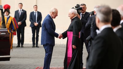 Monsignor Leonardo Sapienza welcomes King Charles in the courtyard of San Damaso. Reuters
