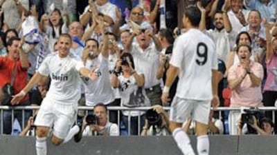 Real Madrid's Karim Benzema, left, celebrates after scoring against Rosenborg during a Santiago Bernabeu Trophy match in Madrid.