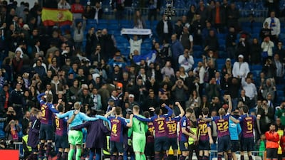Barcelona players celebrate after a win that leaves them 12 points clear of Real. AP