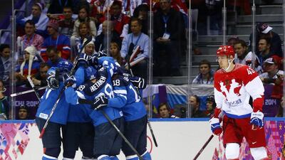 Finland's Teemu Selanne celebrates his goal with his linemates as Russia's Valeri Nichushkin skates away during the first period of their men's quarter-finals ice hockey game at the 2014 Sochi Winter Olympic Games, February 19, 2014. Mark Blinch / Reuters