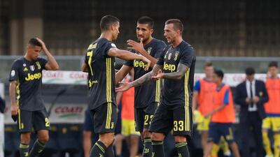Federico Bernardeschi, right, celebrates his late winning goal with Cristiano Ronaldo, left, and Emre Can, centre. AP Photo