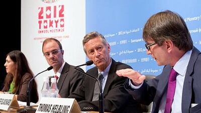 From left, the IMF's Gita Bhatt, Jorg Decressin, Olivier Blanchard and Thomas Heibling outline the World Economic Outlook in Tokyo. Stephen Jaffe / AFP