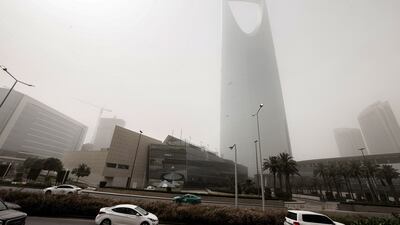 The 302-metre building is almost obscured by dust. AFP