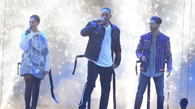 Actress Naomi Scott, left, Will Smith, centre, and Mena Massoud appear on stage. AFP