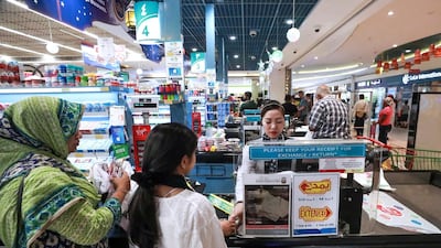 Abu Dhabi, U.A.E., June 14, 2018. Eid Al Fitr shopping at LULU Hypermarket, Mushrif Mall.Shoppers queuing at the cashier counters. Victor Besa / The National Section: National
