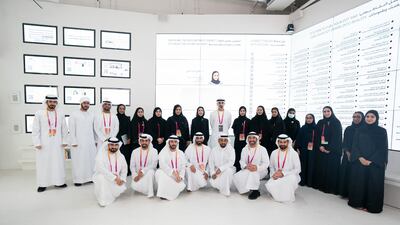 Sheikh Khaled with various officials and staff at the pavilion. Wam