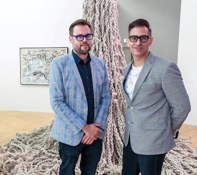 Sam Bardaouil and Till Fellrath in front of an art work by Hassan Sharif Victor Besa / The National