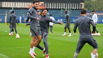 Kylian Mbappe points to Lionel Messi during training. AP
