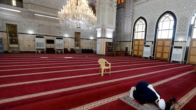 An Iraqi cleric prays in an empty mosque, as Friday prayers were suspended following the spread of the coronavirus disease (COVID-19), in Baghdad, Iraq. Reuters