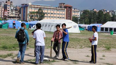 Five teenaged friends organise a cricket match at Tundikhel, a central park which has turned into a relief camp. Pawan Singh / The National