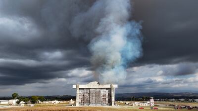 Firefighters work to control a blaze at the north blimp hangar at the former Marine Corps air station in Tustin, California. AP