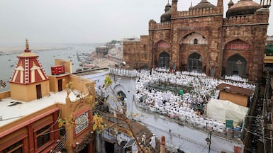 Muslim devotees offer Eid Al Fitr prayers, which marks the end of Ramadan, at Alamgir Mosque, right, along the banks of the river Ganges in Varanasi. AFP