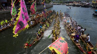 Participants splash water from their dragon boats as part of a celebration to mark the annual Dragon Boat Festival on Saturday in Hong Kong. Tyrone Siu / Reuters