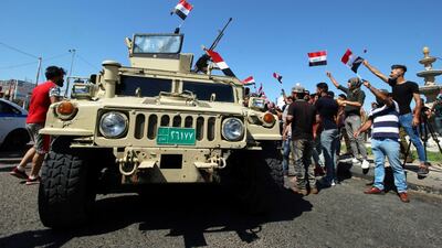 Iraqi demonstrators hold Iraqi flags during an anti-government protest in front of the Governorate building in Basra, Iraq. Reuters