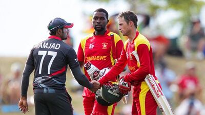 Amjad Ali, left, shakes hands with Zimbabwe batsman Sean Williams at the end of their Cricket World Cup match. Hagen Hopkins / Getty