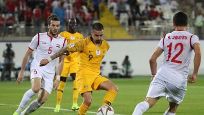 Australia's Maclaren, centre, vies for the ball against Syria's Omar Midani and Hussein Jwayed. AFP