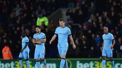 Edin Dzeko, centre, Sergio Aguero, left, and Vincent Kompany, right, of Manchester City react after Crystal Palace's second goal in their 2-1 Premier League defeat at Selhurst Park on Monday night. Jamie McDonald / Getty Images / April 6, 2015