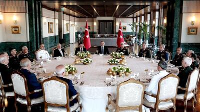 Turkish president Recep Tayyip Erdogan flanked by prime minister Ahmet Davutoglu, meets with members of the High Military Council during a luncheon at the new Presidential Palace in Ankara on August 3. Reuters