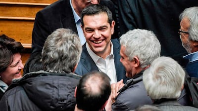Greek prime minister Alexis Tsipras is congratulated after winning a confidence vote at the parliament in Athens. AFP