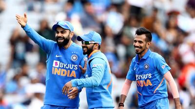 Virat Kohli, Kedar Jadhav and Yuzvendra Chahal of India celebrate the wicket of Tim Southee. Getty
