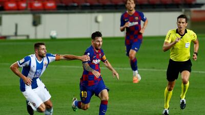 Barcelona's Lionel Messi runs for the ball next to Espanyol's David Lopez. AP Photo