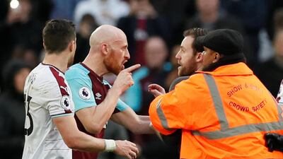 West Ham United's James Collins clashes with a fan who invaded the pitch. David Klein / Reuters