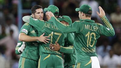Wayne Parnell, left, celebrates with his South Africa teammates taking the wicket of Pakistan’s Mohammad Hafeez on Friday. Hassan Ammar / AP Photo