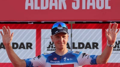 Soudal Quick–Step's Belgian cyclist Tim Merlier celebrates on the podium after winning stage 6 of the 6th UAE Cycling Tour from the Louvre Abu Dhabi to Abu Dhabi Breakwater on February 24, 2024. (Photo by Giuseppe CACACE / AFP)