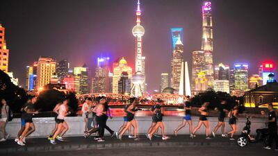 People running at night in Shanghai on July 28, 2017. A growing number of young, educated, urban Chinese are shrugging off the hazardsof running - such as pollution. gawking and dangerous driver - to keep fit in China. AFP Photo