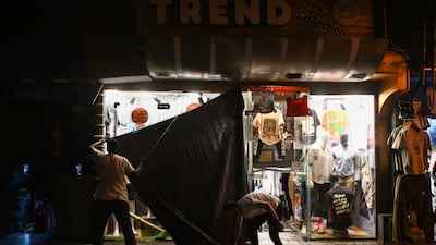 A man closes his shop amid a heatwave in Cairo, after the government had ordered early closure of businesses to save energy. EPA