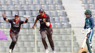 UAE bowler Esha Oza celebrates taking the wicket of Omaima Sohail of Pakistan for a duck.