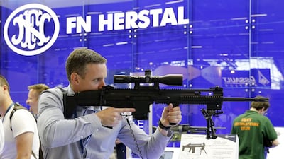 A visitor tries a riffle made by Belgium manufacturer FN Herstal at the Eurosatory international Land and Air-Land Defense and Security fair in Paris. Yoan Valat / EPA