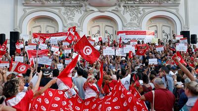 Protesters shout slogans and hold national flags during a rally, demanding equal inheritance rights for women, in Tunis. Reuters
