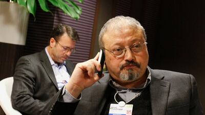Saudi journalist Jamal Khashoggi speaks on his cellphone at the World Economic Forum in Davos, Switzerland in 2011. AP