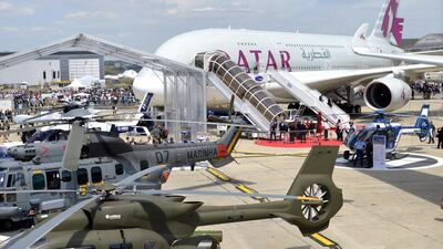 Airbus helicopters and an Airbus A380 airplane of Qatar Airways are pictured at Le Bourget airport. AFP