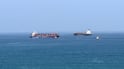 A cargo ship is pictured off coast of the Khor Fakkan Container Terminal, the only natural deep-sea port in the region and one of the major container ports in Sharjah Emirate, along the Gulf of Oman on June 28, 2026. Iran's top diplomat warned on June 28 that any attempt by shipping to bypass its preferred route through the Strait of Hormuz would "increase tensions" in the Middle East, as US and Iranian forces again traded attacks across the vital seaway. (Photo by AFP) /