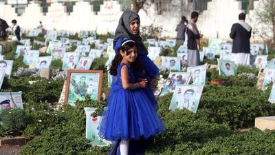 Children in the Yemeni capital Sanaa visit the graves of relatives on the first day of Eid Al Fitr.
