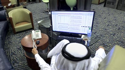 Saudi Tadawul's agreement with the Abu Dhabi bourse is the first among GCC exchanges since the kingdom passed a legislation last year. Above, a broker monitors stock prices in Riyadh. Faisal Al Nasser / Reuters