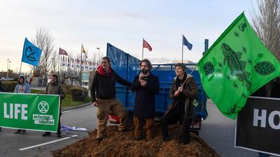 Activists from international climate action group Extinction Rebellion protest after dumping manure outside COP25. AFP