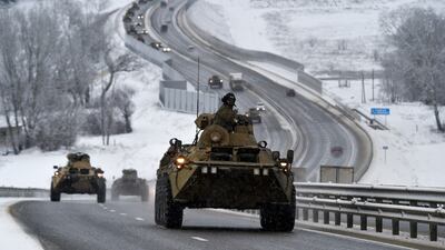 Russian armoured vehicles move along a highway in Crimea. AP