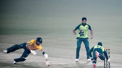 Pakistan's wicketkeeper Mohammad Rizwan runs of South Africa's Reeza Hendricks out as teammate Haris Rauf watches during the first T20 in Lahore. AFP