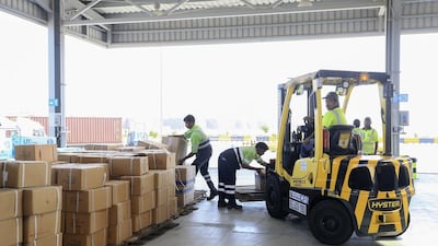 Workers unload shipments for inspection at Dubai Customs in Jebel Ali Port. Sarah Dea / The National